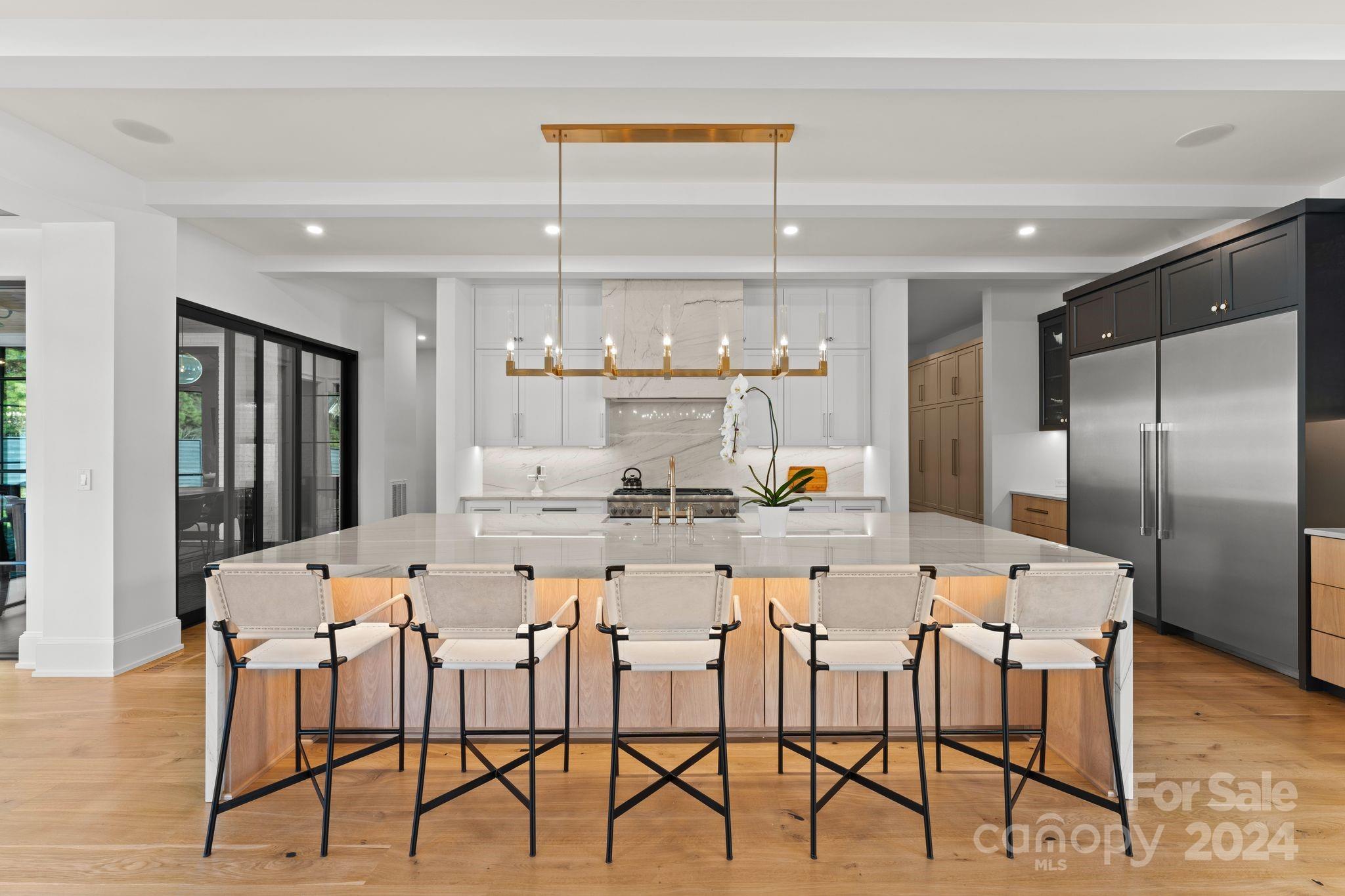 20218 Rainbow Circle Cornelius, NC 28031 - Photo 10 of 44 a dining room with stainless steel appliances kitchen island granite countertop a dining table chairs and a refrigerator