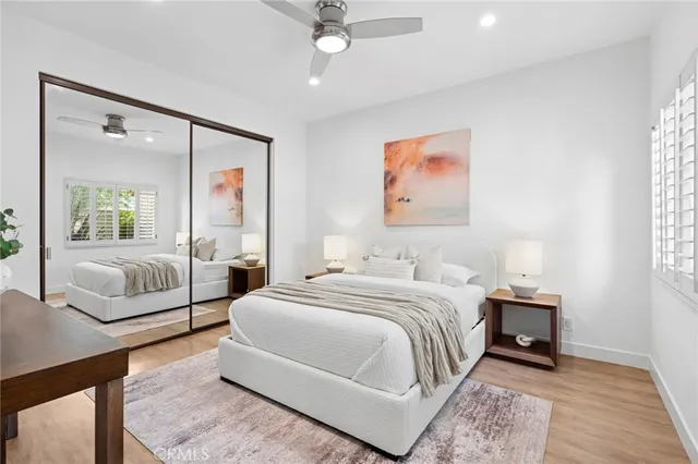 a bedroom with a large bed and a chandelier