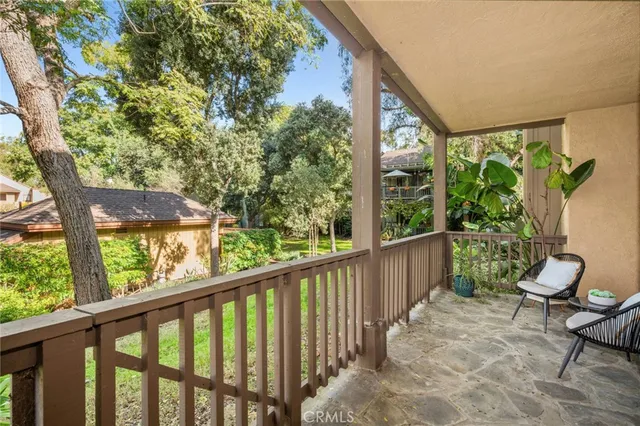 a view of a porch with furniture and a yard