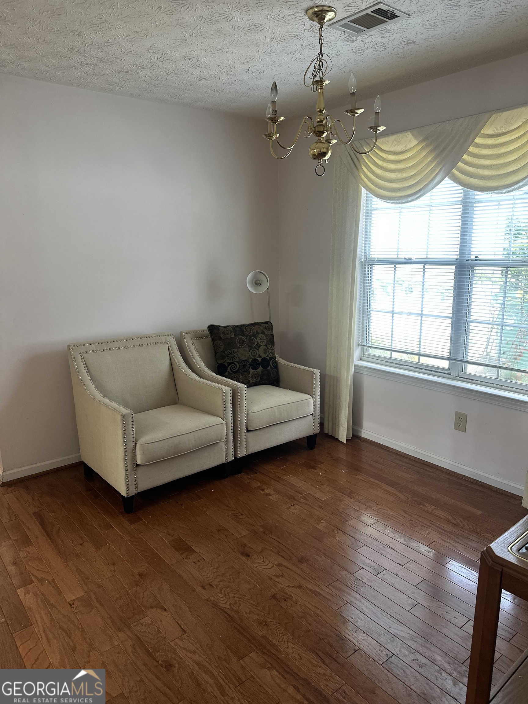 1616 Cobbs Creek Lane Decatur, GA 30032 - Photo 2 of 12 a living room with furniture and a chandelier