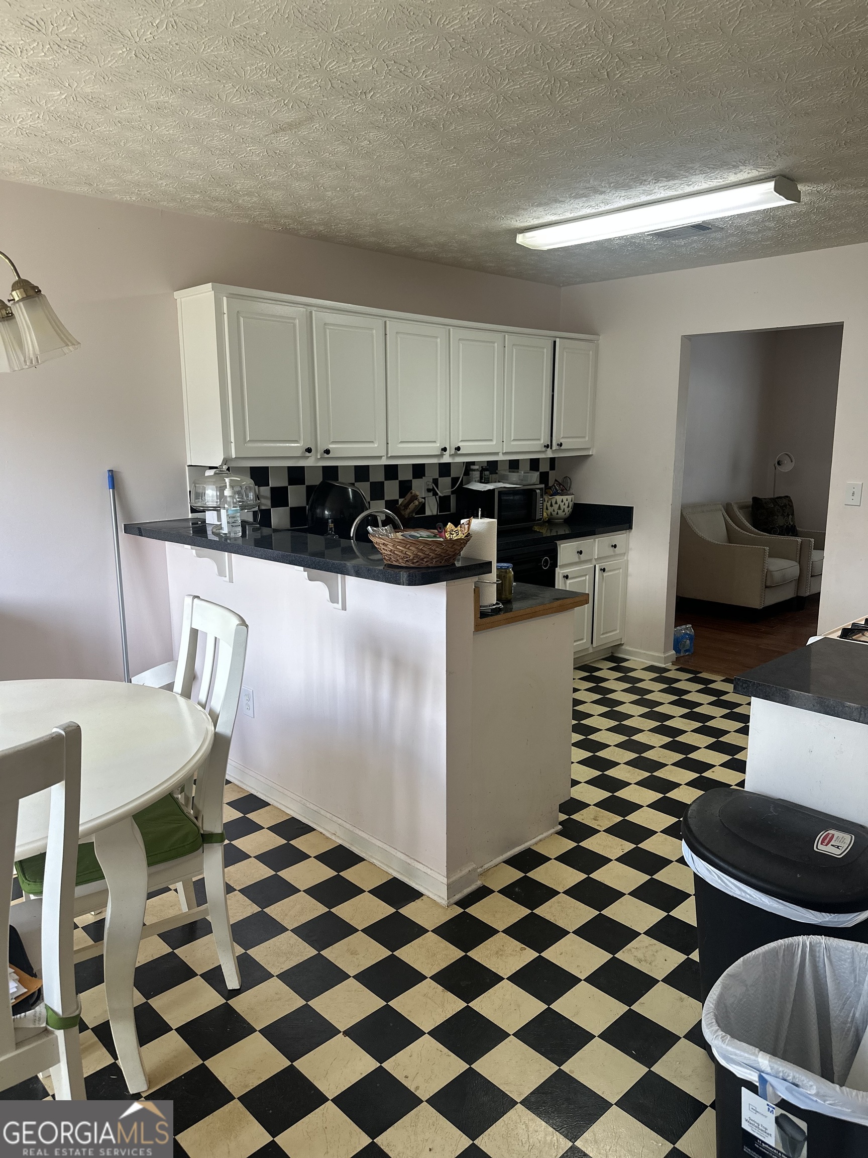 1616 Cobbs Creek Lane Decatur, GA 30032 - Photo 4 of 12 a kitchen with a checkered floor and white appliances