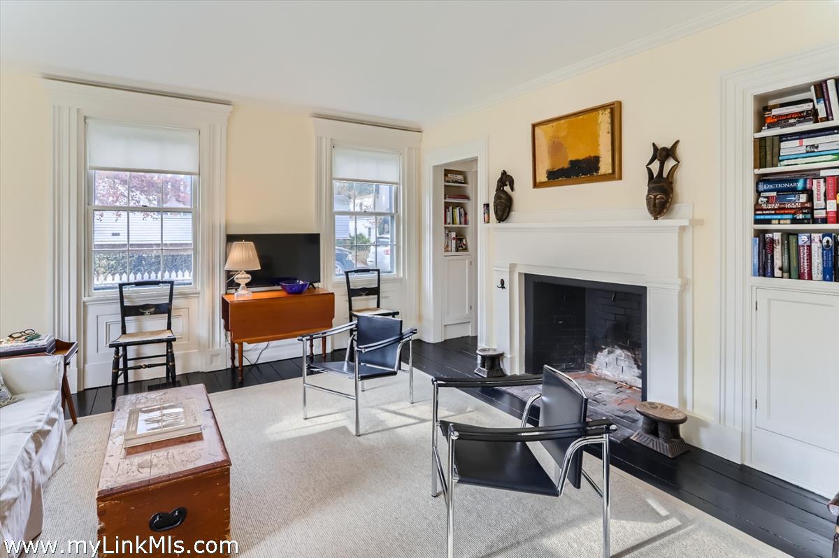 27 Spring Street Vineyard Haven, MA 02568 - Photo 26 of 58 a living room with furniture a rug and a fireplace