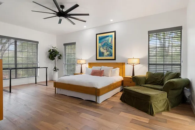 a bedroom with a bed couch and a window