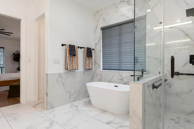 a bathroom with a bathtub and shower