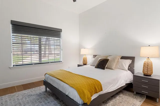 a bedroom with a bed and a window