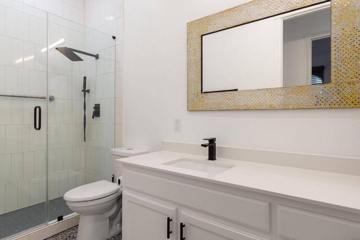 346 The Oaks Boulevard Elgin, TX 78621 - Photo 21 of 39 a bathroom with a sink a toilet and shower