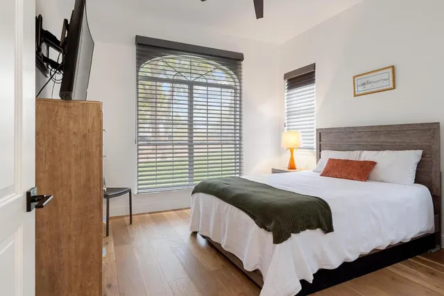 a bedroom with a bed and wooden floor