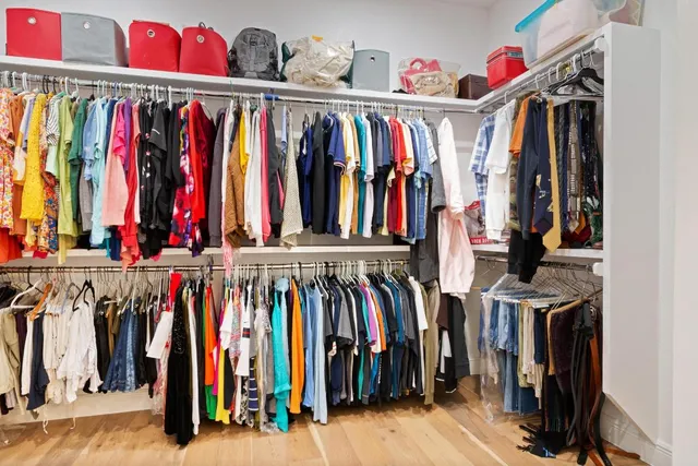 a view of walk in closet with clothes