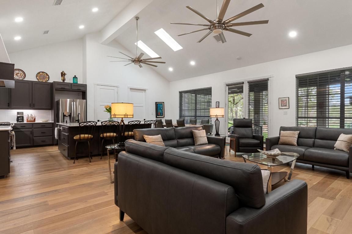 346 The Oaks Boulevard Elgin, TX 78621 - Photo 7 of 39 a living room with furniture kitchen view and a wooden floor