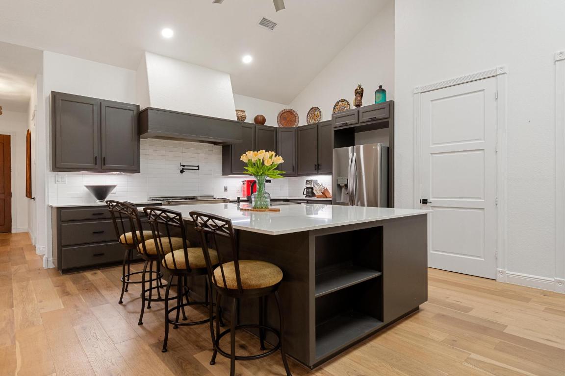 346 The Oaks Boulevard Elgin, TX 78621 - Photo 10 of 39 a kitchen with stainless steel appliances a dining table chairs refrigerator and sink