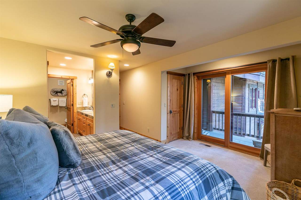 1755 Grouse Ridge Road Truckee, CA 96161 - Photo 11 of 20 a bed room with a bed and a chandelier