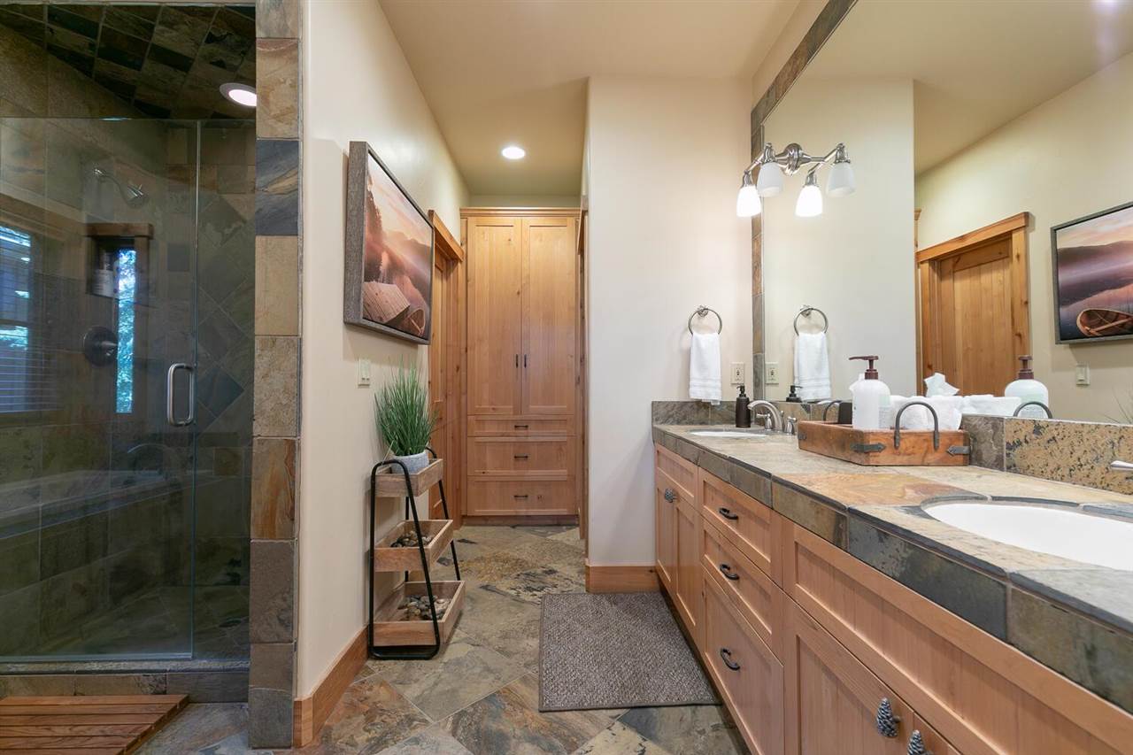 1755 Grouse Ridge Road Truckee, CA 96161 - Photo 13 of 20 a spacious bathroom with a granite countertop sink a mirror and a shower