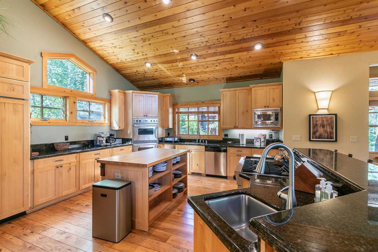 1755 Grouse Ridge Road Truckee, CA 96161 - Photo 4 of 20 a kitchen with stainless steel appliances granite countertop a sink a stove and a wooden cabinets