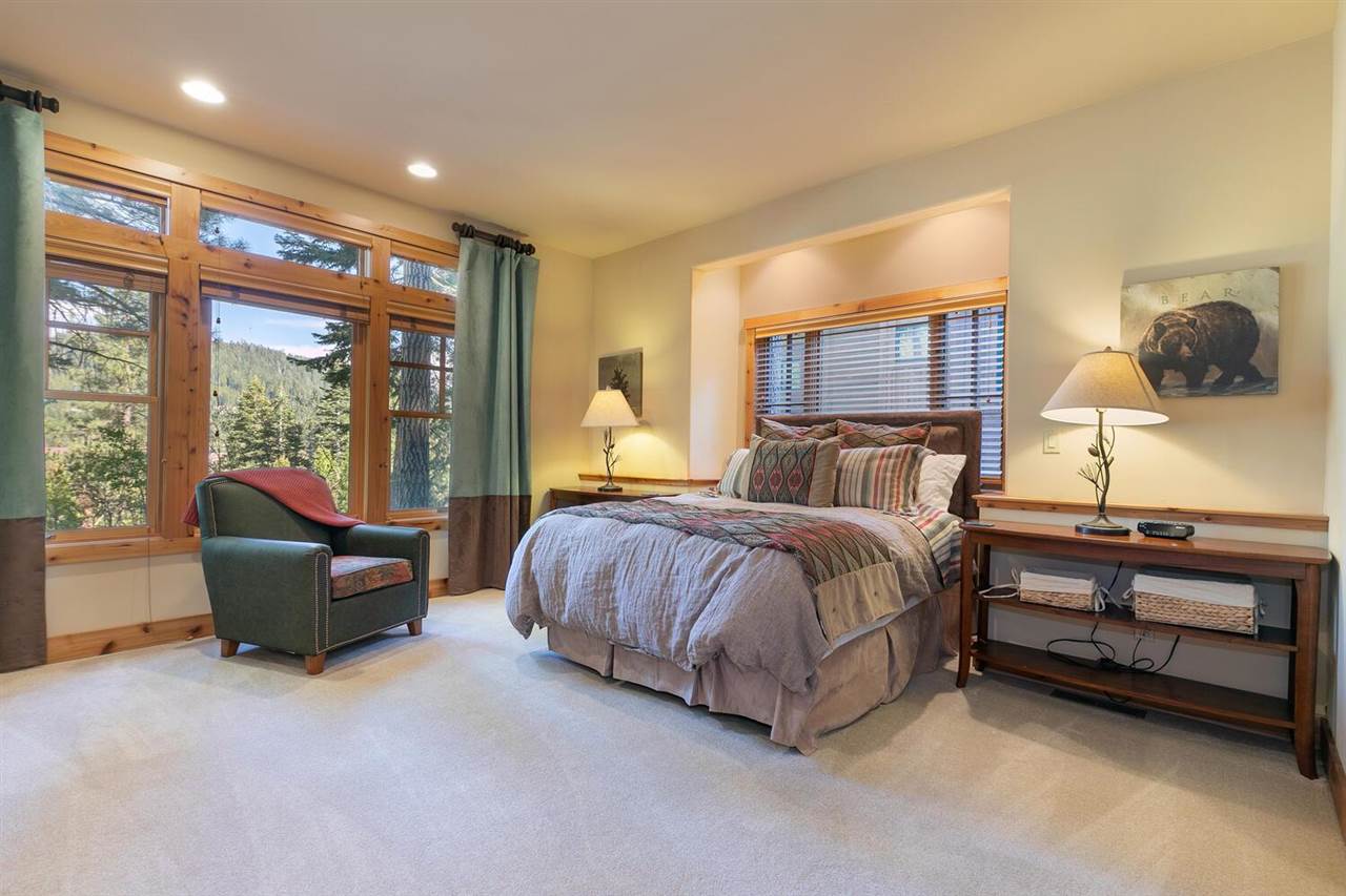 1755 Grouse Ridge Road Truckee, CA 96161 - Photo 8 of 20 a spacious bedroom with a bed and glass window