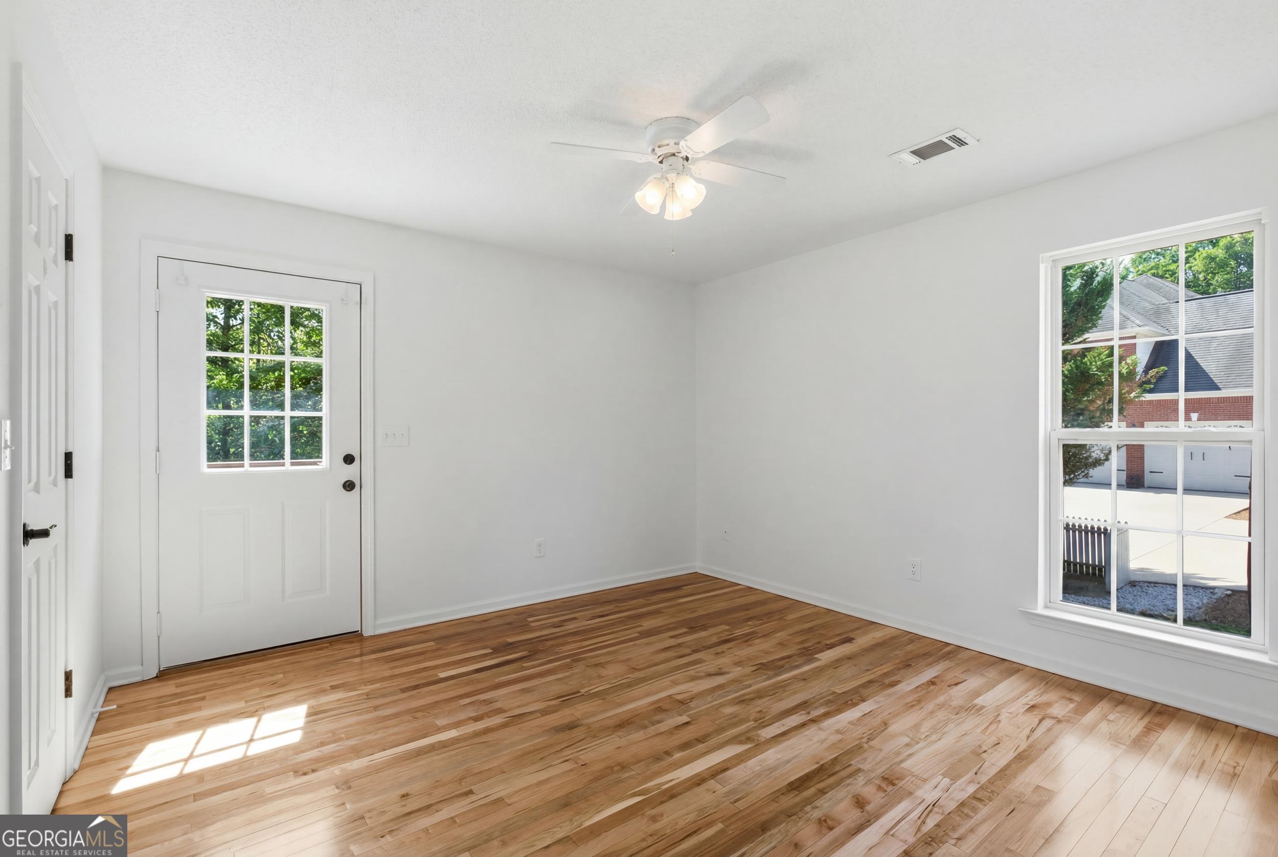 171 Winding Way Hartwell, GA 30643 - Photo 25 of 37 a view of a big room with wooden floor and windows in a room