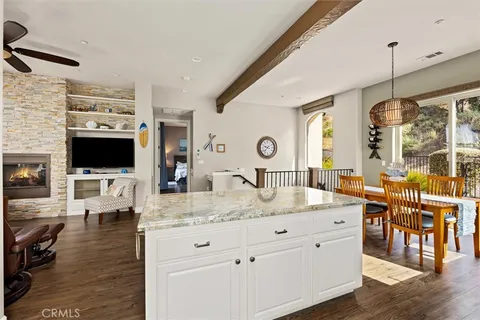 a view of living room with kitchen island furniture and flat screen tv