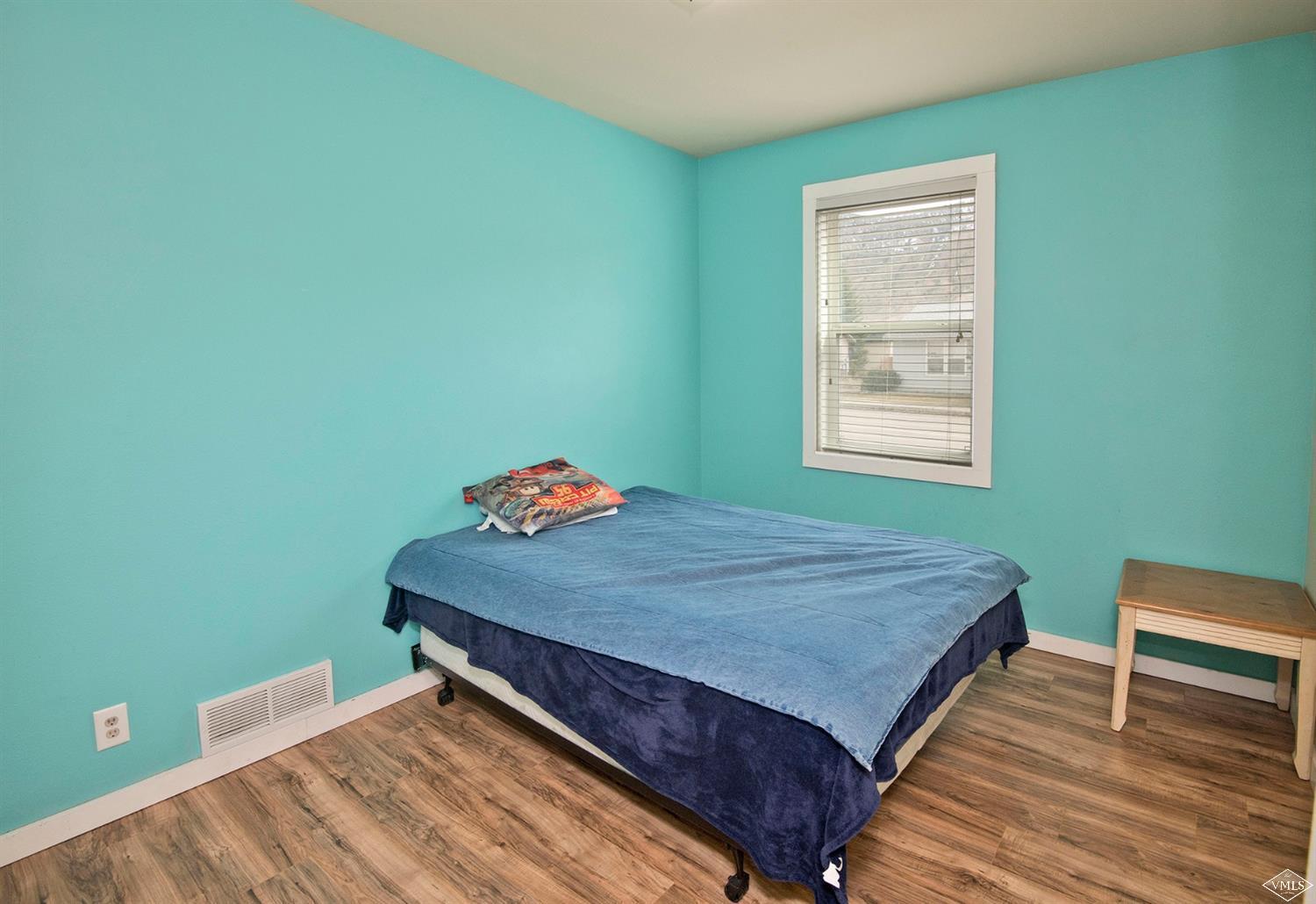 10 Salmon Loop Gypsum, CO 81637 - Photo 11 of 25 a bed sitting in a bedroom next to a window with wooden floor