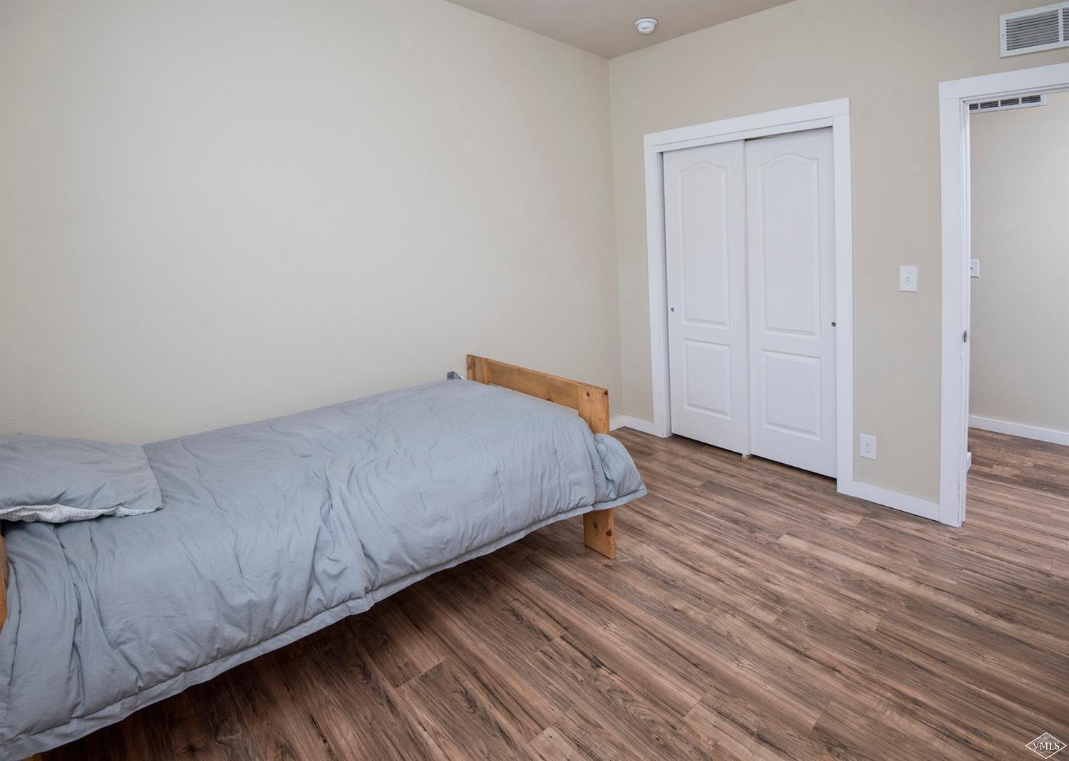 10 Salmon Loop Gypsum, CO 81637 - Photo 14 of 25 a bedroom with a bed and wooden floor