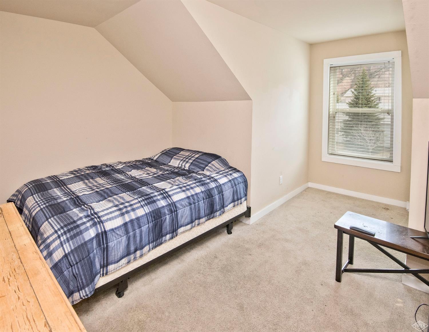 10 Salmon Loop Gypsum, CO 81637 - Photo 19 of 25 a bedroom with a bed and a window