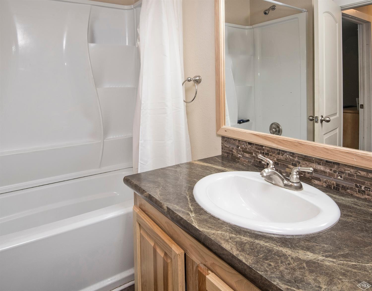 10 Salmon Loop Gypsum, CO 81637 - Photo 20 of 25 a bathroom with a sink and a mirror