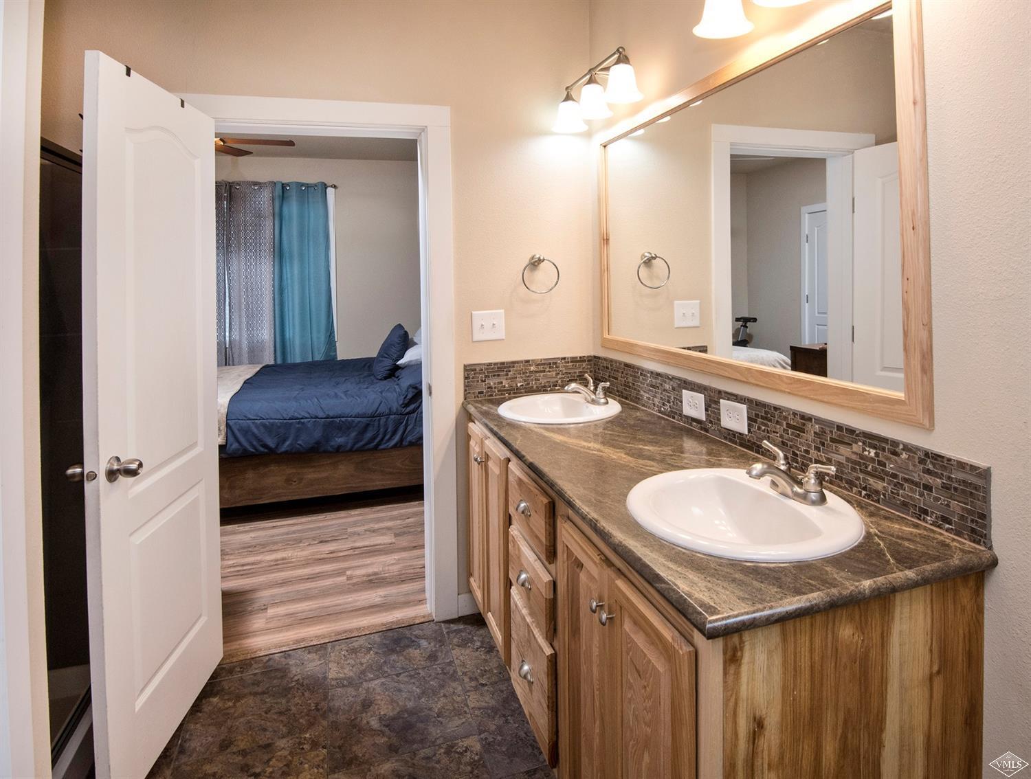 10 Salmon Loop Gypsum, CO 81637 - Photo 9 of 25 a en suite bathroom with a sink and a mirror