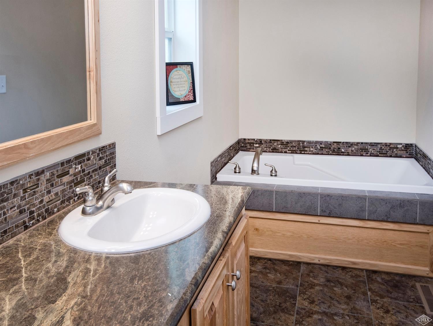 10 Salmon Loop Gypsum, CO 81637 - Photo 10 of 25 a bathroom with a sink a mirror and bathtub
