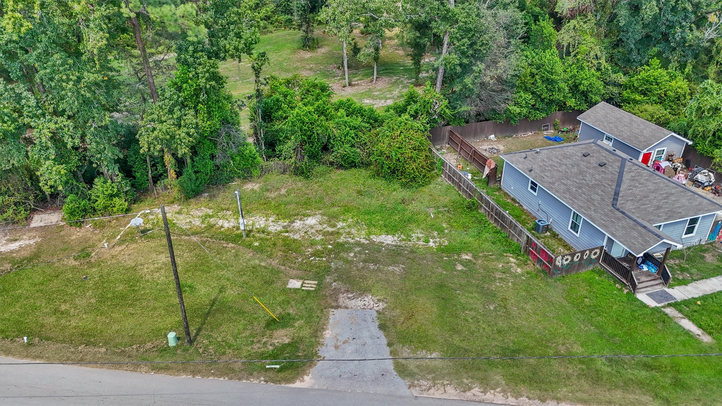 17023 Main Street Splendora, TX 77372 - Photo 3 of 9 a backyard of a house with lots of green space
