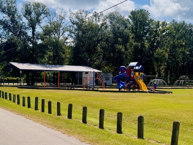 17023 Main Street Splendora, TX 77372 - Photo 9 of 9 a view of swimming pool with seating area and trees in the background