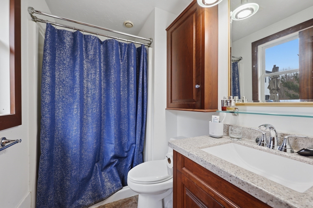 128 Derby Street Worcester, MA 01604 - Photo 18 of 34 a bathroom with a granite countertop sink toilet and mirror
