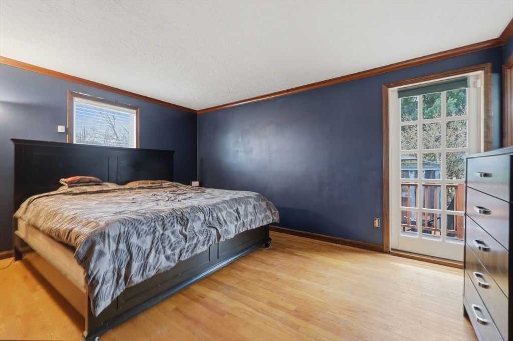 128 Derby Street Worcester, MA 01604 - Photo 19 of 34 a bed sitting in a bedroom next to a window