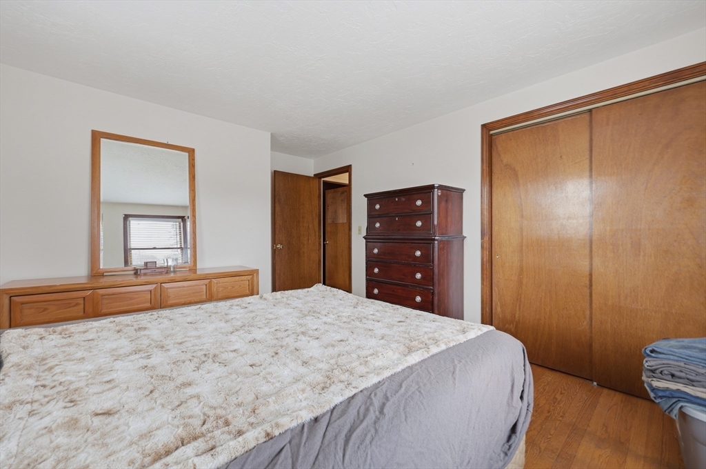 128 Derby Street Worcester, MA 01604 - Photo 22 of 34 a bedroom with a bed and a dresser