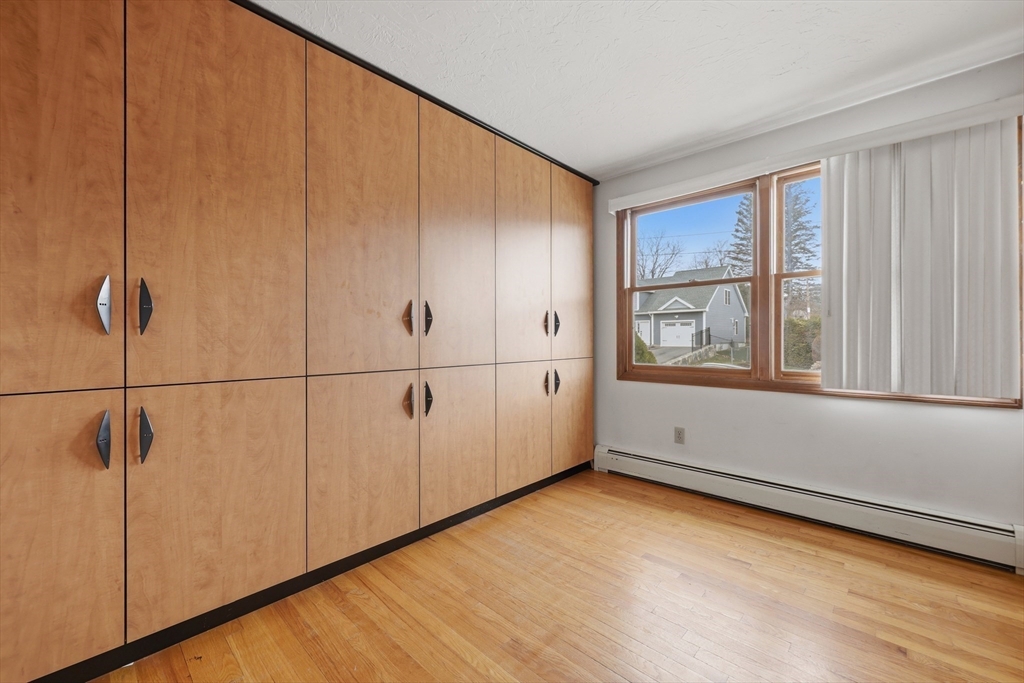 128 Derby Street Worcester, MA 01604 - Photo 24 of 34 a view of an empty room with wooden floor and a window