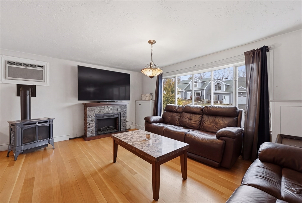 128 Derby Street Worcester, MA 01604 - Photo 5 of 34 a living room with furniture a flat screen tv and a fireplace