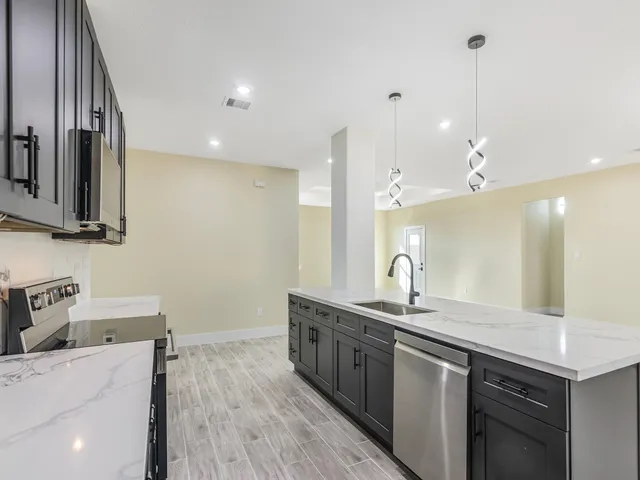 a bathroom with a sink a large mirror and a shower