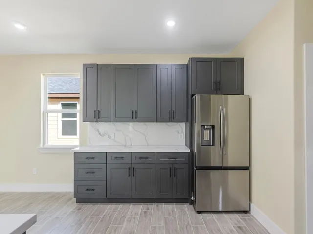 a kitchen with a refrigerator sink and cabinets