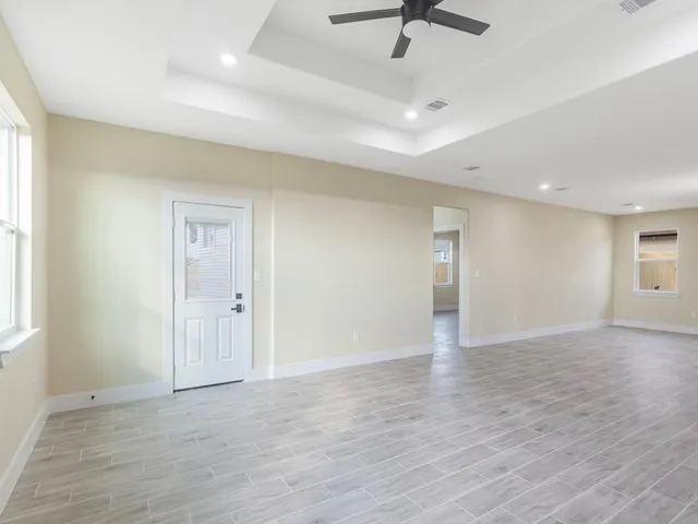 wooden floor in an empty room with a window