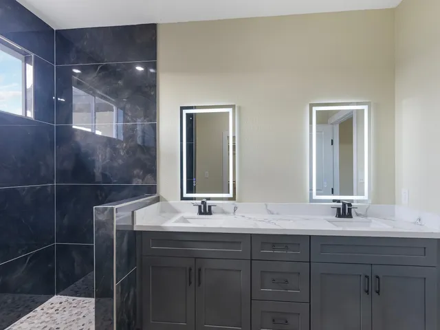 a bathroom with a double vanity sink and a mirror