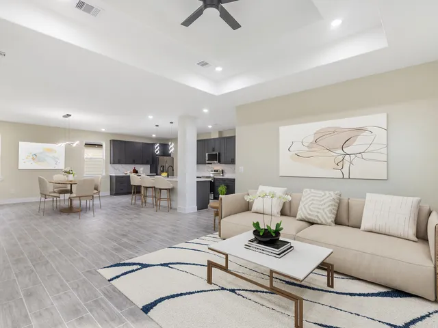 a living room with furniture and kitchen view
