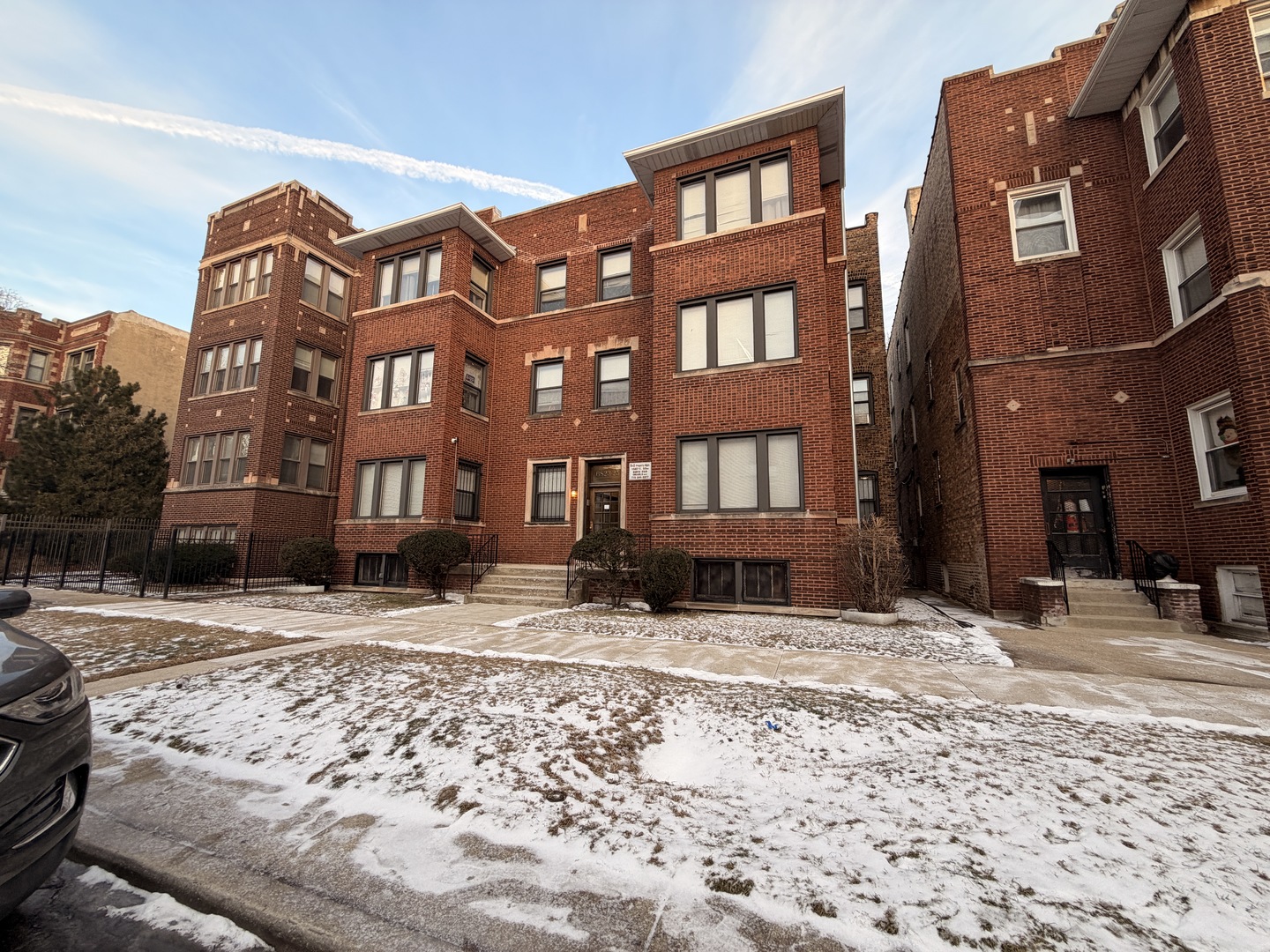 a view of a building with a snow on the side of a road
