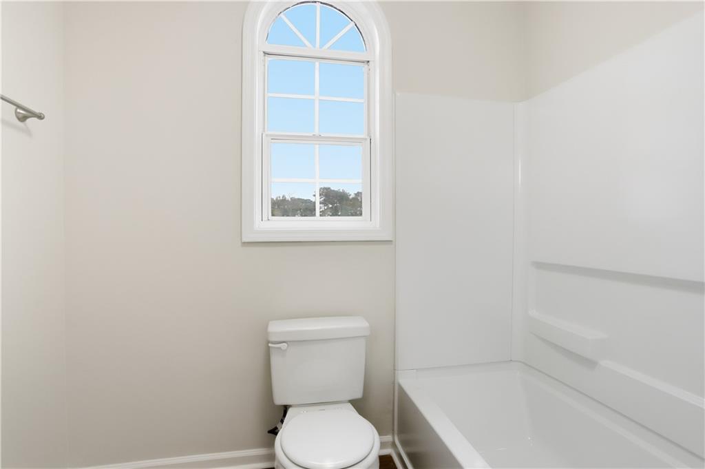 5556 Claridge Circle Stonecrest, GA 30038 - Photo 20 of 25 a white toilet sitting next to a bathroom sink