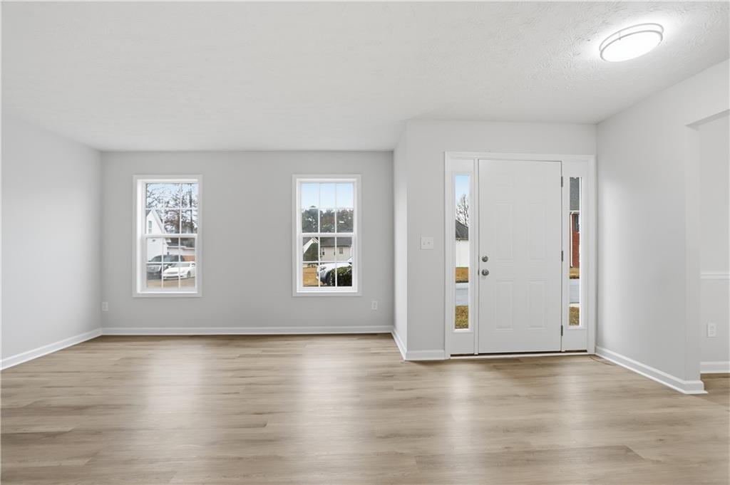 5556 Claridge Circle Stonecrest, GA 30038 - Photo 2 of 25 an empty room with wooden floor and windows