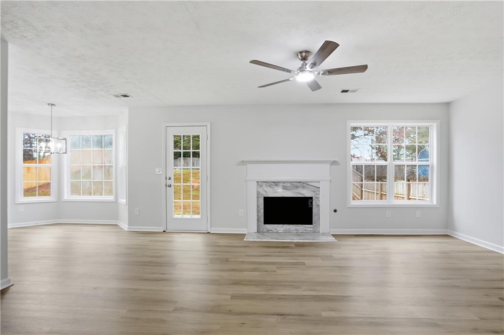 5556 Claridge Circle Stonecrest, GA 30038 - Photo 5 of 25 a view of an empty room with wooden floor and a window