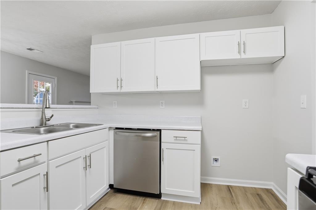 5556 Claridge Circle Stonecrest, GA 30038 - Photo 8 of 25 a kitchen with cabinets appliances and a sink