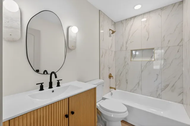 a bathroom with a sink a toilet and a mirror