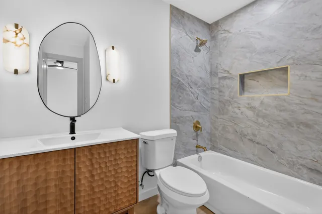 a bathroom with a toilet a sink and bathtub