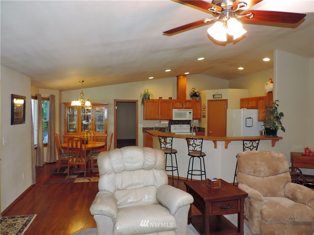 107 Hillcrest Road Chehalis, WA 98532 - Photo 7 of 25 a living room with furniture kitchen view and a chandelier