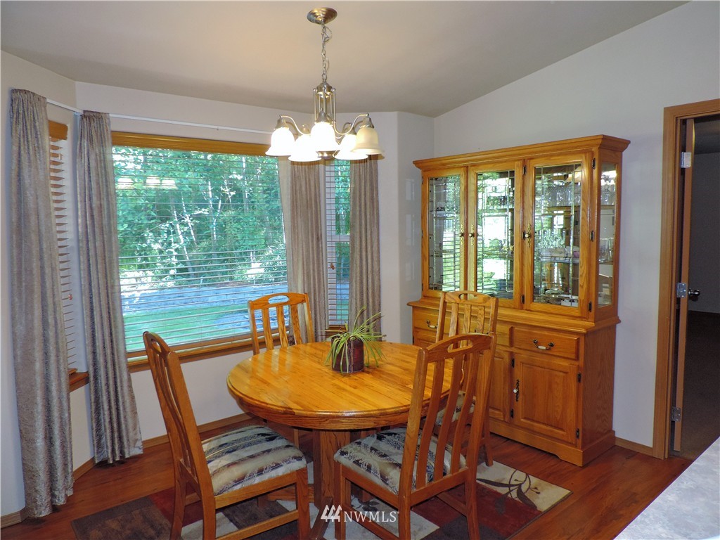 107 Hillcrest Road Chehalis, WA 98532 - Photo 8 of 25 a dining room with furniture a chandelier and wooden floor