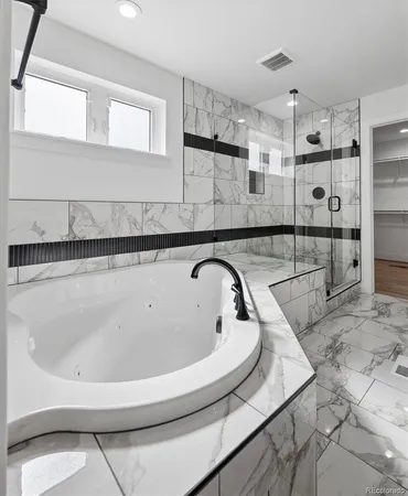 a bathroom with a bathtub and a shower