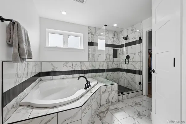 a bathroom with a bathtub and a shower