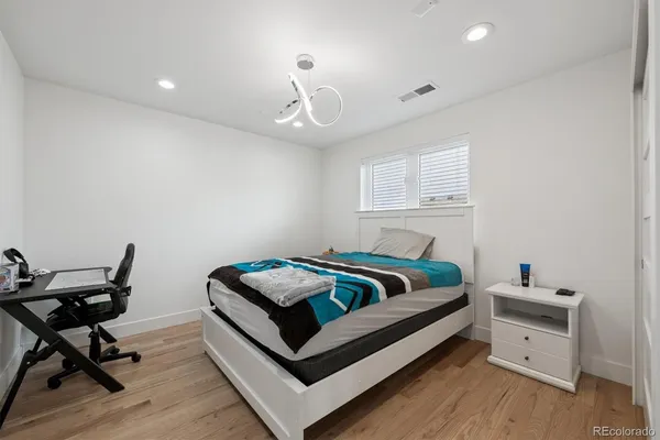 a bed room with a bed and a chair